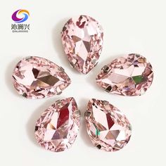 four pink diamonds are arranged on a white surface