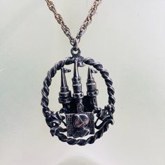 Vintage Gothic Castle Necklace Coro Goth Halloween Pendant designer ITEM DESCRIPTION: Unique Vintage CORO Goth style castle pendant and chain. circa estimated 1970s-80s This medallion is embossed with a Medieval castle and knight symbolism. Pendant is signed "Coro". This necklace has a more bronzed metal tone compared to the more silver or pewter toned metal castle pendant. MEASUREMENTS: The antiqued Medallion measures 1 1/2 inches tall and 1 1/8 inches wide. The uniquely linked chain is 18 inch Vampire Princess, Antique Medallion, Vintage Retro Decor, Goth Halloween, Gothic Castle, Halloween Pendant, Goth Style, Vintage Gothic, Medieval Castle