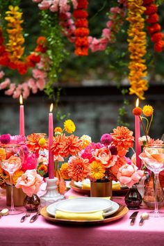 pink and yellow flowers in vases on display at a wedding or bridal event