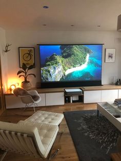 a large flat screen tv mounted to the side of a wall in a living room