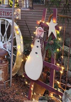 a snowman statue sitting on top of a wooden sled