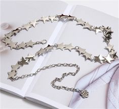 Starry metal chain belt with a rose charm extension. Will fit most sizes because it can be hooked on any part with a jump ring. 28" length of stars, 12" length of extension Trendy Metal Waist Chain Gift, Trendy Metal Waist Chain As Gift, Trendy Metal Waist Chain Perfect As A Gift, Trendy Silver Chain Belt As Gift, Trendy Silver Chain Link Waist Chain, Trendy Adjustable Chain Belt As Gift, Trendy Silver Metal Chain Belt, Metal Chain Belt As Gift, Metal Chain Belt, Ideal As Gift