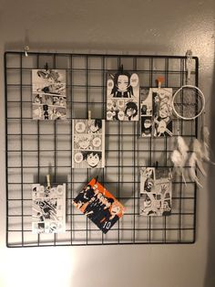 a wire rack with pictures and magnets on it