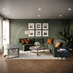 a living room with green couches and pictures on the wall above them, along with a coffee table