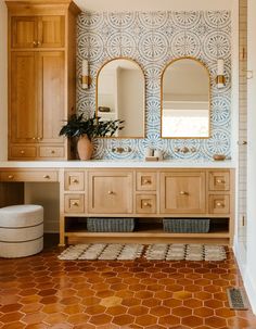 a bathroom with wooden cabinets and tile flooring, two mirrors on the wall above the vanity