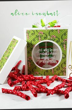 a christmas card with red and green bows on it, surrounded by other holiday decorations