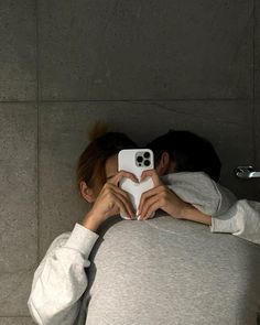 a person taking a selfie in front of a mirror with their cell phone up to their face