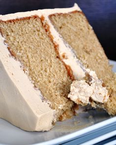 a piece of cake with white frosting on a plate