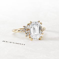 an engagement ring with a large diamond surrounded by smaller diamonds