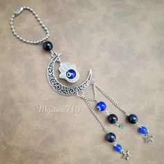 a silver chain with blue beads hanging from it