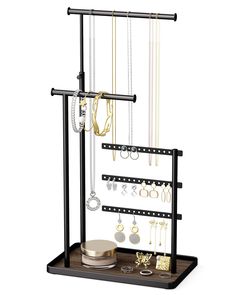 a jewelry rack with several necklaces and earrings on it, along with other accessories