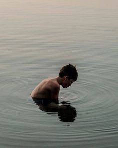 a young boy is swimming in the water