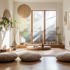 a living room filled with lots of furniture and plants on top of it's wooden floor