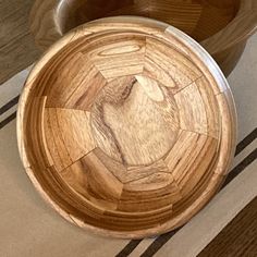 two wooden bowls sitting on top of a table