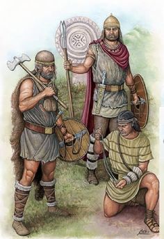 two men dressed in roman armor and holding spears are standing next to another man with a shield