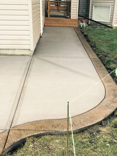 a concrete walkway in front of a house