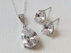 Wedding Cubic Zirconia Silver Dainty Earrings Necklace Bridal Jewelry Set with .925 Sterling Silver Chain. CHAIN is 18 inches (45.7 cm) long, PENDANT is about 1 inch (8mm) long including bail. EARRINGS are about 0.31 inch (10 mm). BRIDAL EARRINGS SECTION: https://www.etsy.com/shop/LanaChayka?ref=seller-platform-mcnav§ion_id=11638940 BRIDAL JEWELRY SETS SECTION: https://www.etsy.com/shop/LanaChayka?ref=seller-platform-mcnav§ion_id=25839214 BRIDAL NECKLACES SECTION: https://www.etsy.com/shop/LanaC White Diamond-accented Teardrop Earrings For Wedding, White Diamond Accent Teardrop Earrings For Wedding, White Diamond Accents Teardrop Earrings For Wedding, White Teardrop Wedding Earrings With Diamond Accents, Wedding Jewelry Sets With Cubic Zirconia In Drop Shape, Wedding Jewelry Sets With Drop Matching Earrings, Wedding Jewelry Set With Drop Earrings, Silver Pear-shaped Jewelry Sets For Wedding, Champagne Jewelry