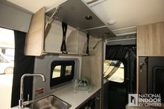 the interior of a camper with sink and kitchen area in it's center