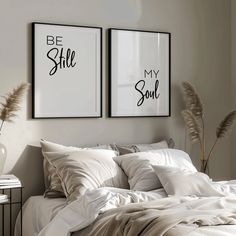 two framed pictures above a bed in a bedroom with white sheets and pillows on it