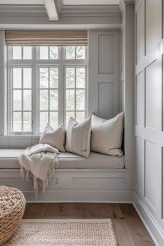 a window seat with pillows and blankets on it