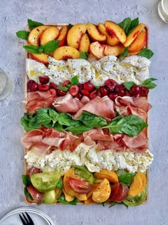 a platter filled with lots of different types of fruits and veggies on top of each other