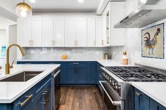 A mosaic of a rooster above a stove in a kitchen with blue cabinets and white countertops. Redo Kitchen Cabinets, Mosaic Tile Kitchen, Best Kitchen Cabinets, Blue Kitchen Cabinets, Two Tone Kitchen, Black Kitchen Cabinets, Blue Cabinets, Kitchen Cabinet Remodel, Kitchen Cabinet Colors