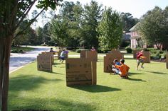 children playing in the yard with cardboard boxes