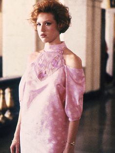 a woman in a pink dress posing for the camera