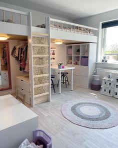 a loft bed is in the middle of a room with bunk beds and desks