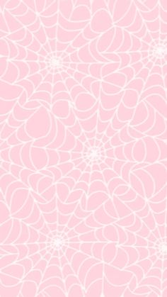 a pink and white background with an intricate design in the shape of a spider's web