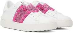 Low-top buffed calfskin sneakers in white. Crystal-cut accents and pyramid studs throughout. · Lace-up closure · Graphic patch at padded tongue · Padded collar · Buffed leather lining · Treaded rubber sole Supplier color: White/Pink Casual White Sneakers With Rhinestone Rivets, Pink Studded Sneakers For Streetwear, Luxury White Sneakers With Spikes, Luxury White Spiked Sneakers, Luxury White Studded Sneakers, Off White Vulcanized Sneakers Pink, White Low-top Sneakers With Rhinestone Rivets, Valentino Rockstud Sneakers, Pink Valentino Sneakers