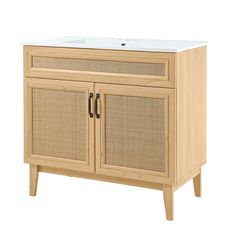 an image of a bathroom vanity with wicker doors and white counter top on it