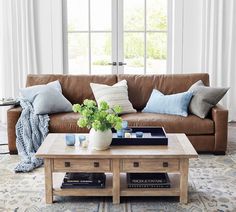 a living room with a brown couch and coffee table