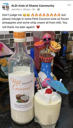 a bottle of alcohol sitting next to a glass filled with ice cream on top of a counter