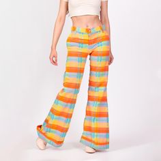 Vintage 70s colorful plaid low rise bell bottoms, with chunky cuffed ankles. A few condition notes, see details below. Measurements and Condition:  Fits like: Extra small Fabric: Feels like cotton/poly, textured Brand: None Condition: Good, with a tiny green spot on the front of the right hip, some faint discoloration in sections at the leg hems, a couple small holes through on layer of fabric on the lower edge at the back leg hems, and a 2" patched section on the back of each thigh. Waist: 28.2 Low Rise Bell Bottoms, Plaid Bell Bottoms, Hippie Trousers, Bell Bottoms, Trousers Women, Vintage 70s, Low Rise, Capri Pants, Halloween Shopping