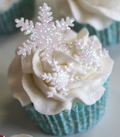 two cupcakes decorated with white frosting and flowers