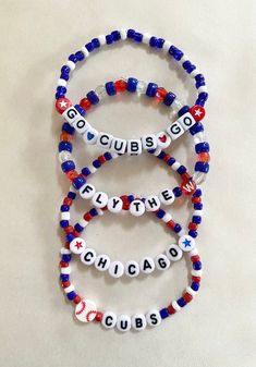 three red, white and blue beaded bracelets with the word cubs on them