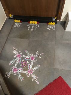 the floor is decorated with white and pink designs on it, along with red rugs