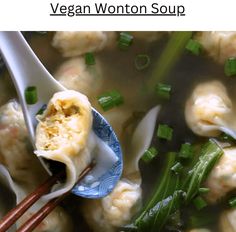 a blue plate topped with dumplings and green onions