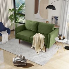 a living room with a green couch and chair in front of a large open window