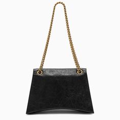 Black leather shoulder bag from Balenciaga featuring a chain top handle, a curved design, three internal compartments, an internal zipped pocket, a metal logo on the front, a magnetic closure and gold-tone metal hardware.Width 31 cm x Height 20 cm x Depth 7 cm Adjustable shoulder strap length min 50 cm - max 115 cm100% Calf leather Modern Bags With Gold Chain, Modern Office Flap Bag With Chain Strap, Modern Shoulder Bag With Metal Logo, Modern Evening Flap Bag With Chain Strap, Modern Flap Bag With Chain Strap For Everyday Use, Modern Chain Strap Flap Bag For Everyday, Chic Office Shoulder Bag With Metal Logo, Everyday Leather Shoulder Bag With Gold Chain, Chic Shoulder Bag With Metal Logo For Everyday Use