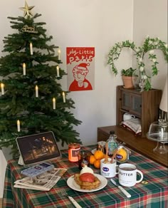 a small christmas tree in the corner of a room with food and drinks on it