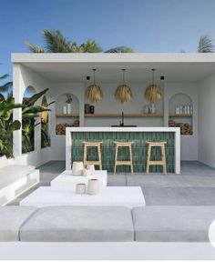 an outdoor living area with white furniture and palm trees in the background, including two stools