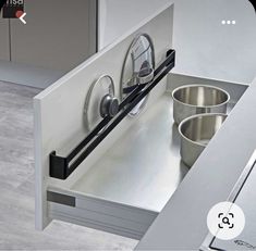 a kitchen sink with pots and pans on it