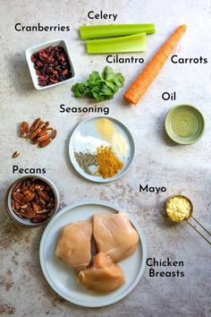 the ingredients for chicken broth laid out on a white table with carrots, celery, celery, cilantro, almonds, pecans and seasoning