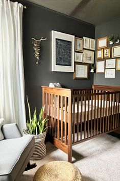 a baby crib in a room with pictures on the wall