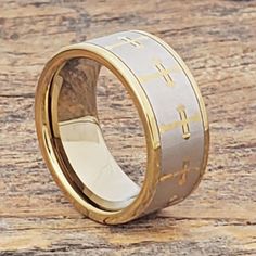 a gold and silver wedding ring with the words jesus in two different languages on it