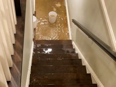 the stairs are flooded with water and there is a coffee cup on top of it