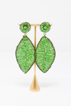 The Lavish by TM Green Leaf Earrings are beautiful addition to any outfit! Material: Enameled wire, hypoallergenic and nickel-freeOrigin: Hand made in Brazil Stud closure Hand crocheted Lightweight 3.5" drop Lavish by Tricia Milaneze is ethereal and lace designs are ideal for women looking for an attractive accessory, but avoiding solid, heavy jewelry. All pieces are extremely feminine, wearable and accessible. Elegant Green Hypoallergenic Beaded Earrings, Green Metal Beaded Earrings For Party, Green Leaf-shaped Party Jewelry, Green Metal Beaded Party Earrings, Luxury Ornate Green Earrings, Bohemian Green Leaf-shaped Jewelry, Green Teardrop Nickel-free Chandelier Earrings, Green Leaf-shaped Earrings, Hypoallergenic Green Flower-shaped Earrings