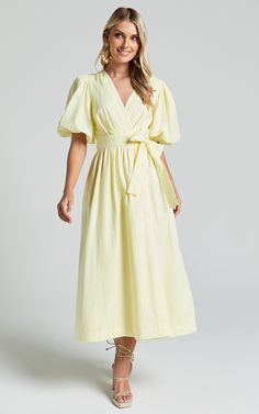 Get ready to turn heads in the Amalie The Label Franc Midi Dress! This stunning yellow dress is perfect for any occasion, from casual days out to party nights. With its A-line silhouette and wrap style, it flatters all body types and accentuates your waist for a flattering fit. Made from lightweight linen, this dress is breathable and comfortable for all-day wear. The puff sleeves add a touch of femininity, while the plunge neckline adds a hint of allure. Whether you're attending a weekend activ Puff Sleeve Wrap Dress, Pale Yellow Midi Dress, Yellow Modest Outfits, Yellow Puff Sleeve Dress, Yellow Easter Dress, Lemon Product, Pale Yellow Bridesmaid Dresses, Lemon Yellow Dress, Pale Yellow Dress